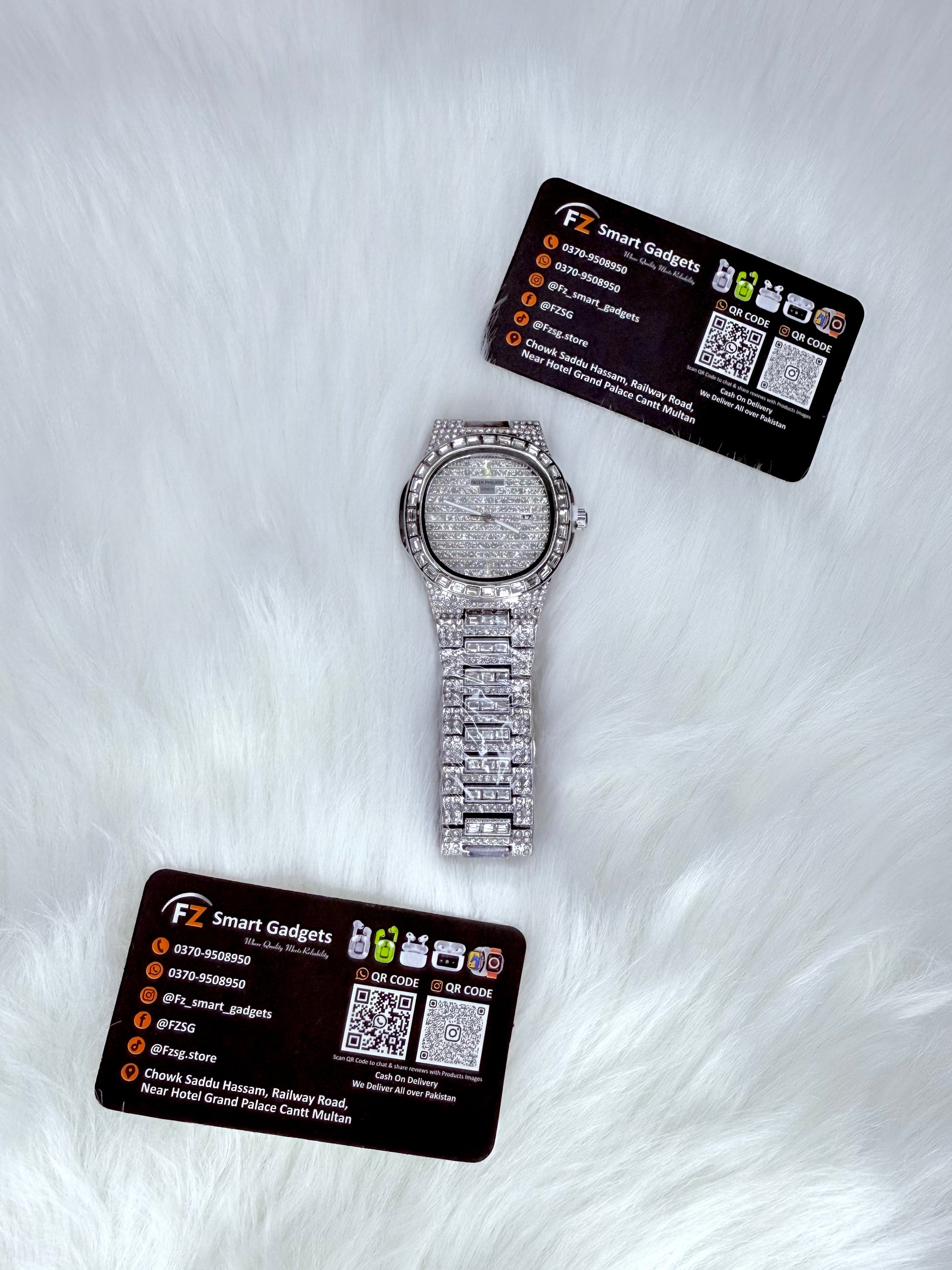 Patek Philippe iced out watch in silver with diamond-encrusted bracelet