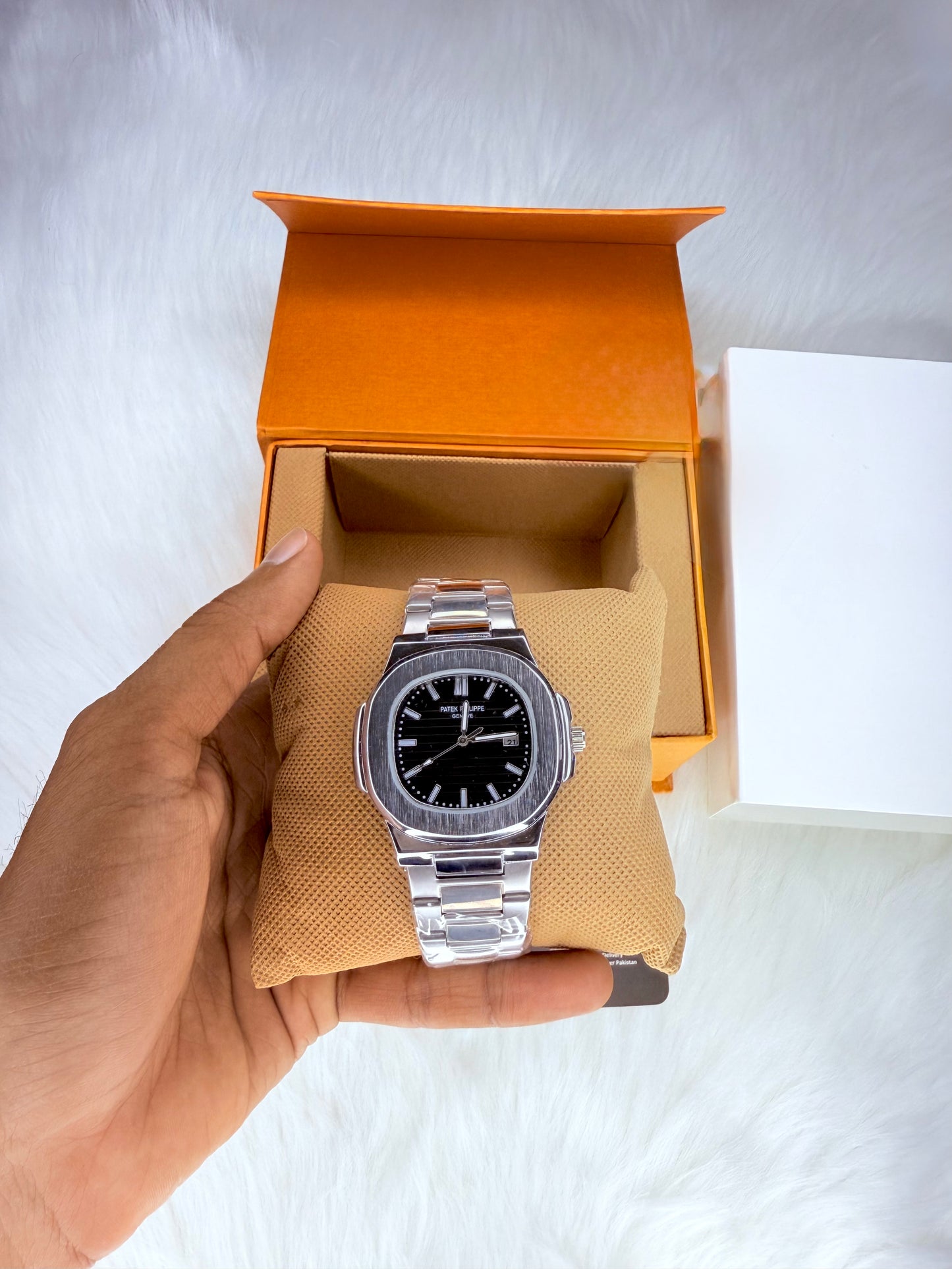 Patek Philippe Geneve watch with black dial and stainless steel bracelet