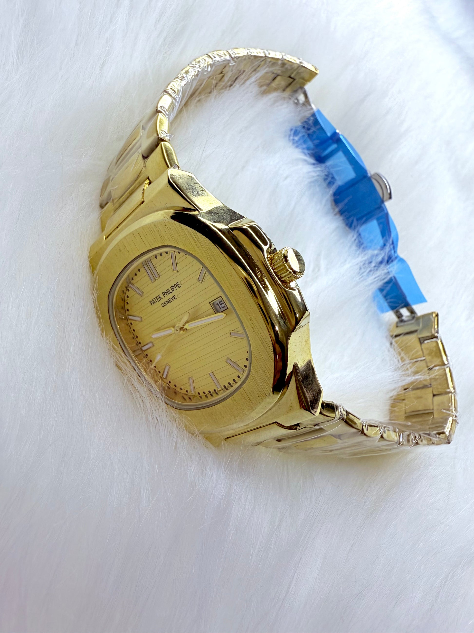Patek Philippe Geneve watch with yellow dial and golden stainless steel bracelet